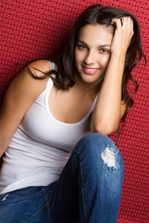 Pretty teen girl wearing ripped jeansの写真素材