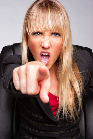 Angry yelling business woman pointingの写真素材