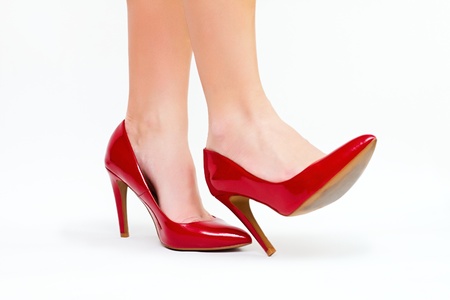 Sexy legs in red high heels isolated on white backgroundの写真素材