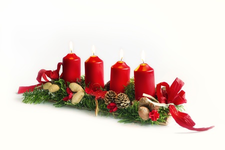 Christmas candlestick with red candles and pine cones isolated on white の写真素材