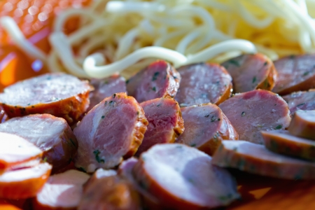Sliced smoked sausage and cheese noodlesの写真素材