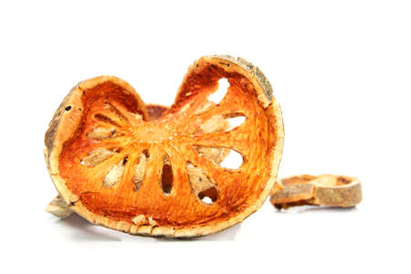 Bale Fruit dried tee. Isolated on white. Bale fruit is tropical fruit with hard exterior cover. The fruit has medicinal value for digestive system. Extensively consumed in rural India and Thailand.の写真素材