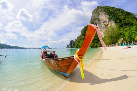 Tropical beach, traditional long tail boat, Poda Bay, Thailandの写真素材