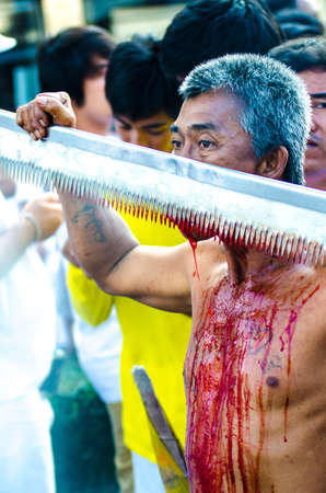 Phuket Vegeterian Festival. Shocking asian tradition - body piercing.のeditorial素材