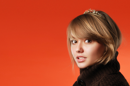 Closeup head portrait of surprisedscared and shy teen girl looking ahead with copy space on red backgroundの写真素材
