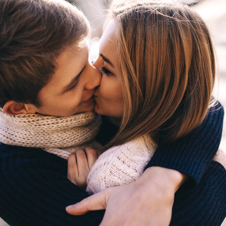 Close up teenager couple in love Kissing in the Bright Autumn Dayの写真素材