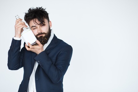 drunk business man holding whiskey bottle with alcoholism problem. Modern person looking messy with...