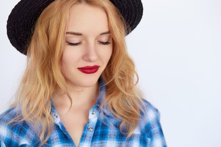 Young woman with blond hair keeping eyes closed. Hipster girl dreamingの写真素材