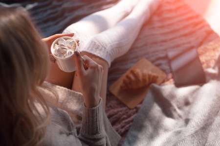 Woman drinking cocoa with marshmallowsの写真素材