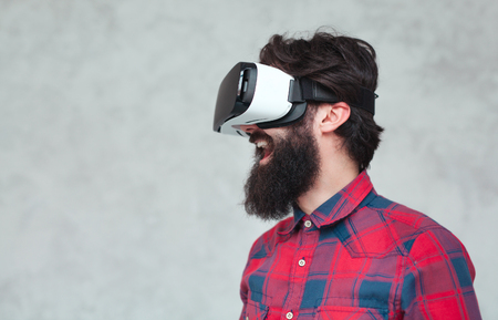 Cheerful man in VR helmetの写真素材