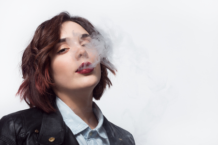 Woman puffing a smokeの写真素材