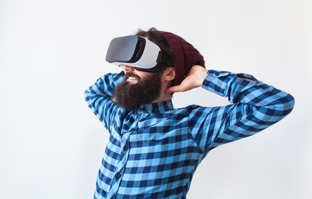 Man holding head playing VR headsetの写真素材
