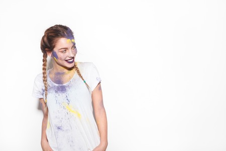 Girl with Holi colors looking on sideの写真素材