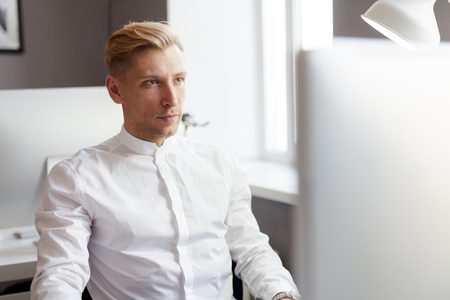 Young man sitting in front of computerの写真素材
