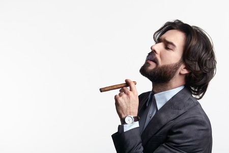 Young businessman smoking cigarの写真素材