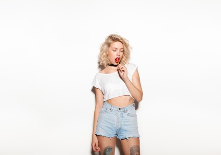 A girl licking a lollipopの写真素材