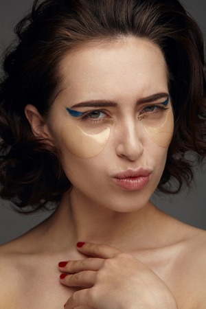 Woman applying eye maskの写真素材