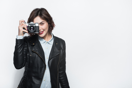 Young stylish girl with retro cameraの写真素材