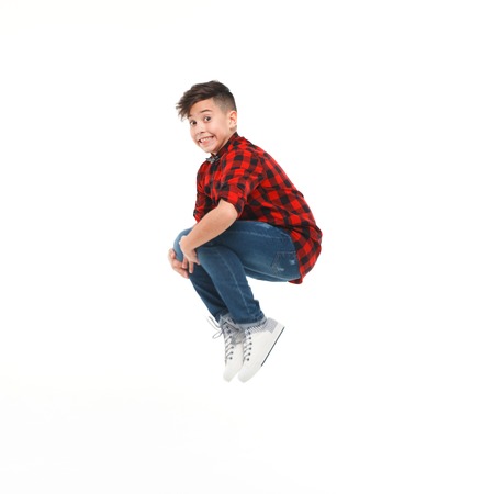 Little boy jumping on white backgroundの写真素材