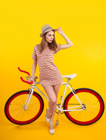 Confident model posing with bicycleの写真素材