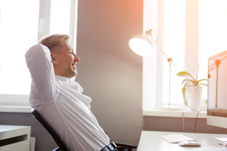 Side view of man at desktopの写真素材