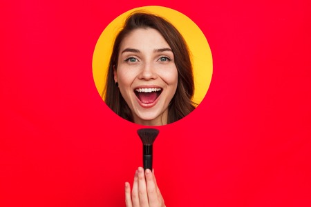 Woman in circle with cosmetic brushの写真素材