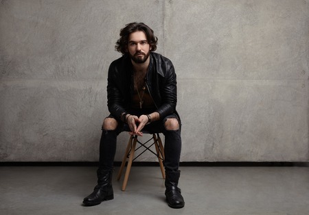 Young stylish man on chairの写真素材