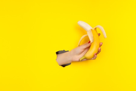 Crop hand with bananaの写真素材