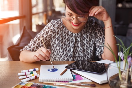 Laughing woman drawing with tabletの写真素材