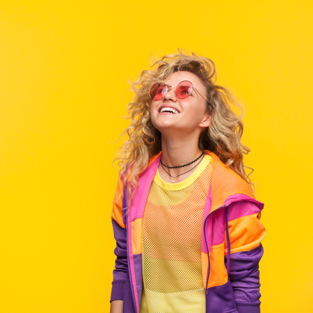 Smiling girl wearing sunglasses looking upの写真素材
