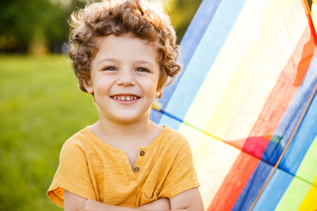 Blonde boy with arms crossed posing outsideの写真素材