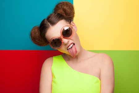Girl in sunglasses showing tongueの写真素材