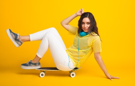 Girl sitting on cruiser leaning on floorの写真素材