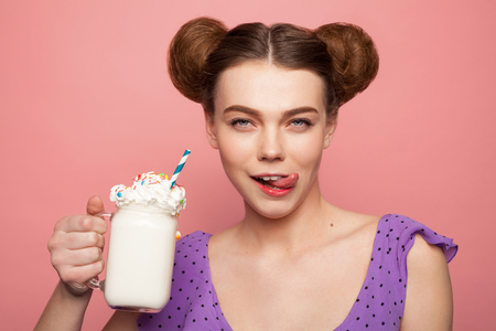 Brunette girl holding glass licking lipsの写真素材