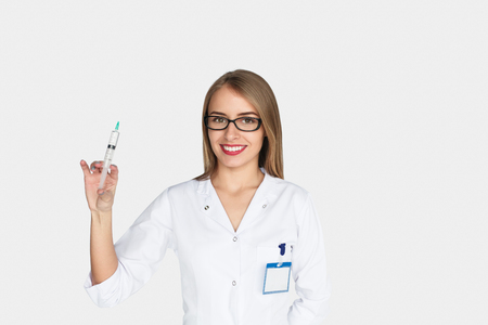 Female doctor holding syringe smilingの写真素材