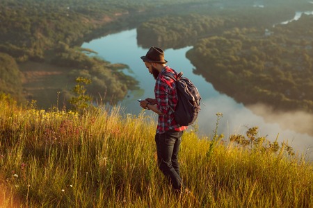 Backpacker with phone traveling