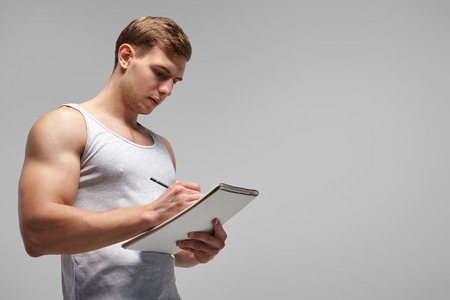 Fit trainer writing in notepadの写真素材