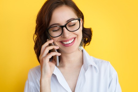 Smiling lady talking phoneの写真素材