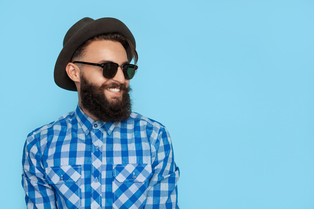 Laughing hipster man on blueの写真素材