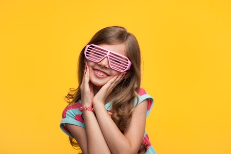 Charming girl posing in sunglassesの写真素材