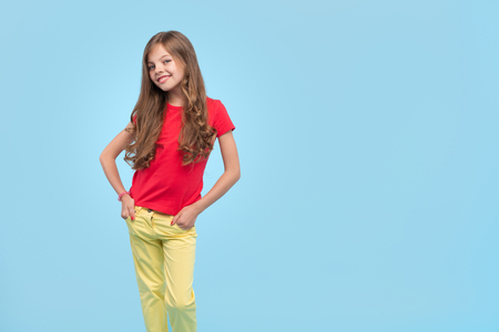 Trendy confident girl on blue backgroundの写真素材