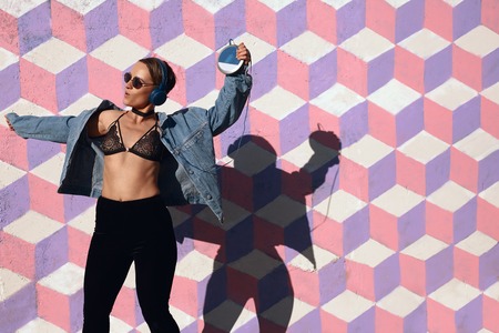 Hipster girl with music playerの写真素材