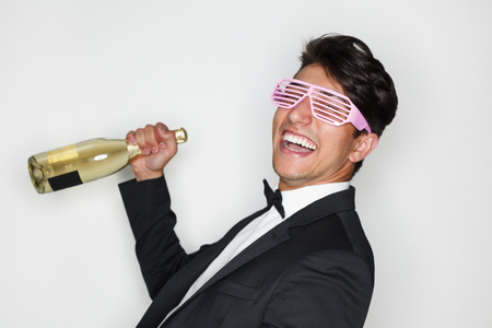 Stylish man with bottle of champagneの写真素材