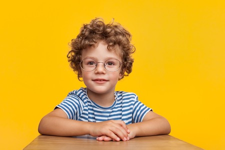 Adorable smart boy in studioの写真素材