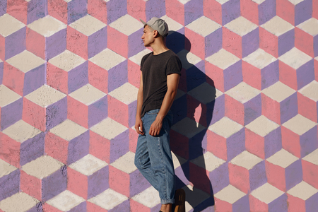 Trendy man on painted wallの写真素材