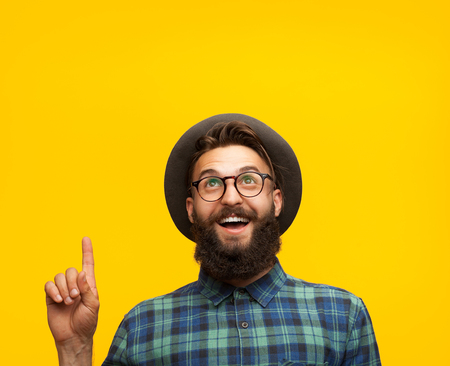 Content man pointing up on orangeの写真素材