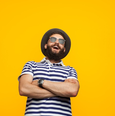 Cheerful man posing on orangeの写真素材