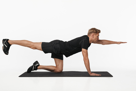 Man exercising on yoga matの写真素材
