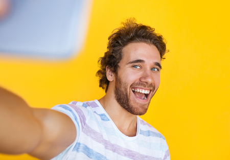 Cheerful man taking selfie