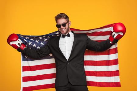 Elegant man in boxing gloves with flagの写真素材